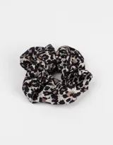 Scrunchie de tela con estampado animal print en tonos negro, marrón y beige.