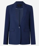 Blazer azul marino de corte sastrero, con solapas con detalle de puntilla en color crema, cierre con un botón dorado y bolsillos delanteros con solapa.