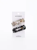 Pack de dos broches para el pelo con diseño abstracto en blanco y negro, y transparente con detalles dorados.