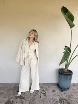 Pantalón de vestir color beige, de corte palazzo y tiro alto.