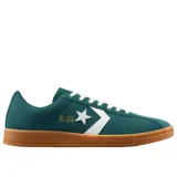 Championes Converse All Star Classic Trainer Ox, color verde oscuro, con logo estrella y chevron en blanco y cordones blancos. Suela de goma color caramelo.