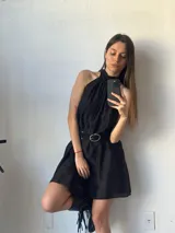 Vestido corto negro con cuello halter y corte evasé.
