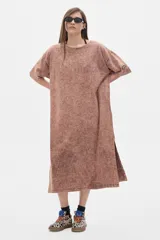 Vestido midi color ladrillo con efecto lavado, de corte amplio, cuello redondo y mangas cortas caídas. Presenta aberturas laterales.