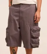 Bermuda masculina super baggy confeccionada en sarga de algodón, con cintura con trabilla, cierre tradicional y bolsillo cargo con cierre por cremallera.