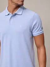 Chomba manga corta color beige con cuello clásico y tapeta de dos botones. Tiene un pequeño logo bordado en el pecho. Corte clásico.