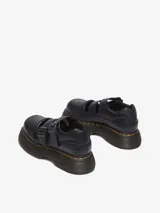 Zapato Mary Jane negro de cuero Milled Nappa, con dos correas ajustables con hebillas, cuello acolchado y una suela inflada de PVC con costura amarilla.