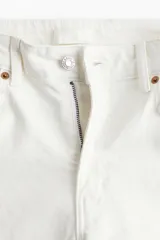 Jean de cinco bolsillos color blanco, de corte ajustado con tiro alto y piernas tobilleras.