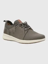 Zapatillas urbanas Hush Puppies Spinal Knit color gris, confeccionadas en cuero certificado y tejido de malla. Cuentan con ajuste de cordones, cuello y lengüeta acolchados, plantilla acolchada y suela de goma con tecnología Spinal para mejorar la postura.