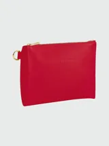 Pochette Longchamp modelo Le Foulonné, color naranja, con cierre superior y logo grabado en el frente.