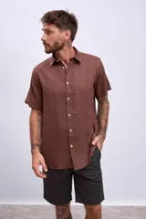 Camisa celeste de lino, de corte clásico, manga corta y cuello italiano.