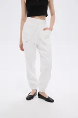 Pantalón babucha blanco con cintura elastizada y cordón ajustable.