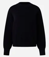 Buzo suéter femenino de tricot color verde esmeralda, con cuello redondo y puños ajustados. Confeccionado con viscosa certificada, poliéster y poliamida.