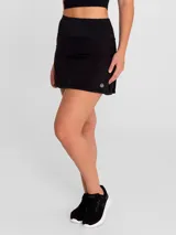 Falda deportiva negra con calza interior, de secado rápido. Diseño acampanado con plisado en la parte trasera, pretina ancha con bolsillo con cierre y bolsillo interior en la calza.