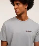 Remera gris de algodón con cuello redondo y manga corta. Estampa frontal con la frase "La Boutique" en color negro.
