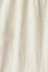 Pantalón de lino color crema, con cintura elástica y cordón ajustable.