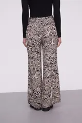 Pantalón de viscosa con estampado abstracto en tonos beige y negro, de corte palazzo y cintura con lazo ajustable.