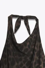 Vestido largo con estampado animal print, cuello halter con lazada y espalda descubierta.
