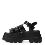 Sandalias negras con plataforma y tiras anchas cruzadas, con hebilla lateral ajustable.