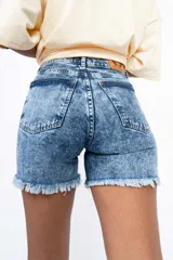 Short de jean celeste con efecto lavado, tiro alto y terminación desflecada.