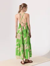 Vestido largo verde con estampado de palmeras, de breteles finos y espalda descubierta.