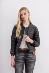 Campera corta negra de nylon rellena con pluma, corte holgado, cuello redondo y bolsillos con cierre.