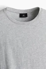 Remera gris de corte ajustado, cuello redondo y manga corta.