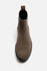 Bota Chelsea color marrón topo de cuero serraje, con elásticos laterales negros, tirador trasero y suela track.