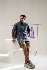 Remera gris con estampado en el frente con la frase "Fear Less". En la espalda tiene un estampado vertical con la frase "More Strength".