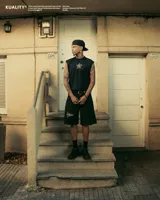 Tank top negro de corte boxy, sin mangas, con un estampado frontal en blanco que incluye una estrella con las letras "SK" en su interior y un punto.