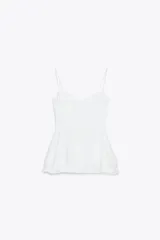 Top blanco de escote corazón y tirantes finos. Tiene corte peplum y cierre lateral con cremallera oculta.