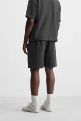 Bermuda negra de corte relaxed fit, con cintura elástica ajustable con cordón, bolsillos frontales y bolsillo trasero de parche.