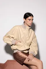 Chaqueta de cuero color marrón con cuello alto y puños de algodón. Cierre delantero con cremallera y dos bolsillos laterales. Talle único.