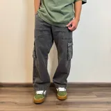 Pantalón jean color beige, corte recto y estilo cargo con bolsillos laterales.