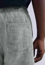 Bermuda verde de tela texturizada con cintura elastizada y cordón de ajuste.