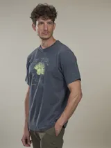 Remera celeste con estampado de un diseño floral en azul y texto en la parte inferior.