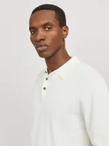 Polo blanco de punto estructurado con fit regular. Cuello polo clásico, mangas cortas y cierre con botones. Tejido con textura sutil.