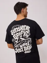 Remera negra de algodón con estampado del logo de la marca Rusty en el frente.