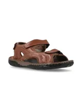 Sandalias de cuero marrón para hombre, con ajuste de velcro en el empeine y en el tobillo. Suela de goma negra con pespuntes en contraste.