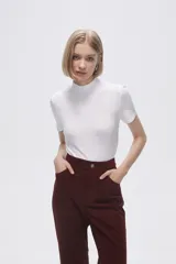 Remera blanca de viscosa con cuello alto y manga corta.
