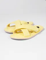 Sandalia amarilla con tiras cruzadas y cierre de velcro, suela de 1 cm de altura.
