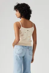 Musculosa de punto color crema con breteles finos y bordado de pequeñas estrellas de colores.