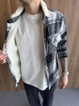 Chaqueta de paño a cuadros blancos y negros con interior de corderito blanco.