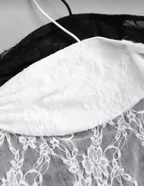 Top tipo corset de encaje floral, disponible en negro y blanco. Presenta un diseño ajustado al cuerpo con escote corazón fruncido y tirantes finos tipo halter ajustables.