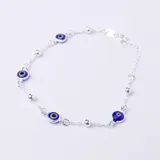 Pulsera de plata 925 con dijes de ojo turco azul y bolitas plateadas.