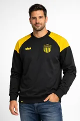 Buzo de felpa negro con mangas raglán amarillas, cuello redondo y puños y ruedo acanalados. Presenta un escudo de Peñarol con estrellas en el pecho izquierdo y el número "1891" en amarillo en el lado derecho.
