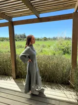 Vestido largo azul marino de lino con cuello mao, escote en V, mangas 3/4 con volados y corte escalonado. Diseño amplio y cómodo.