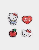 Set de cuatro pines de acrílico con diseños de Hello Kitty y una manzana roja con lunares blancos.