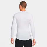 Remera deportiva blanca de manga larga, ajustada al cuerpo, con tecnología Dri-Fit y logo de Nike en el pecho.