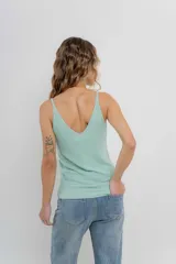 Musculosa amarilla de hilo con brillo sutil, de calce ajustado y breteles finos.