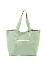 Bolso tipo tote de tela color verde agua con detalles en crudo en asas, borde superior y bolsillo frontal.